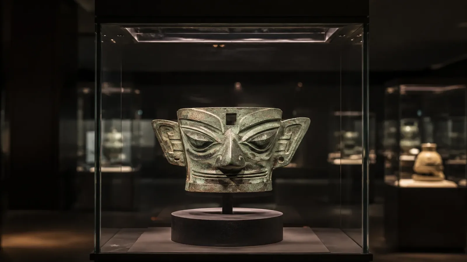 Bronze mask and ancient Shu artifacts displayed in the Sanxingdui Museum in Sichuan