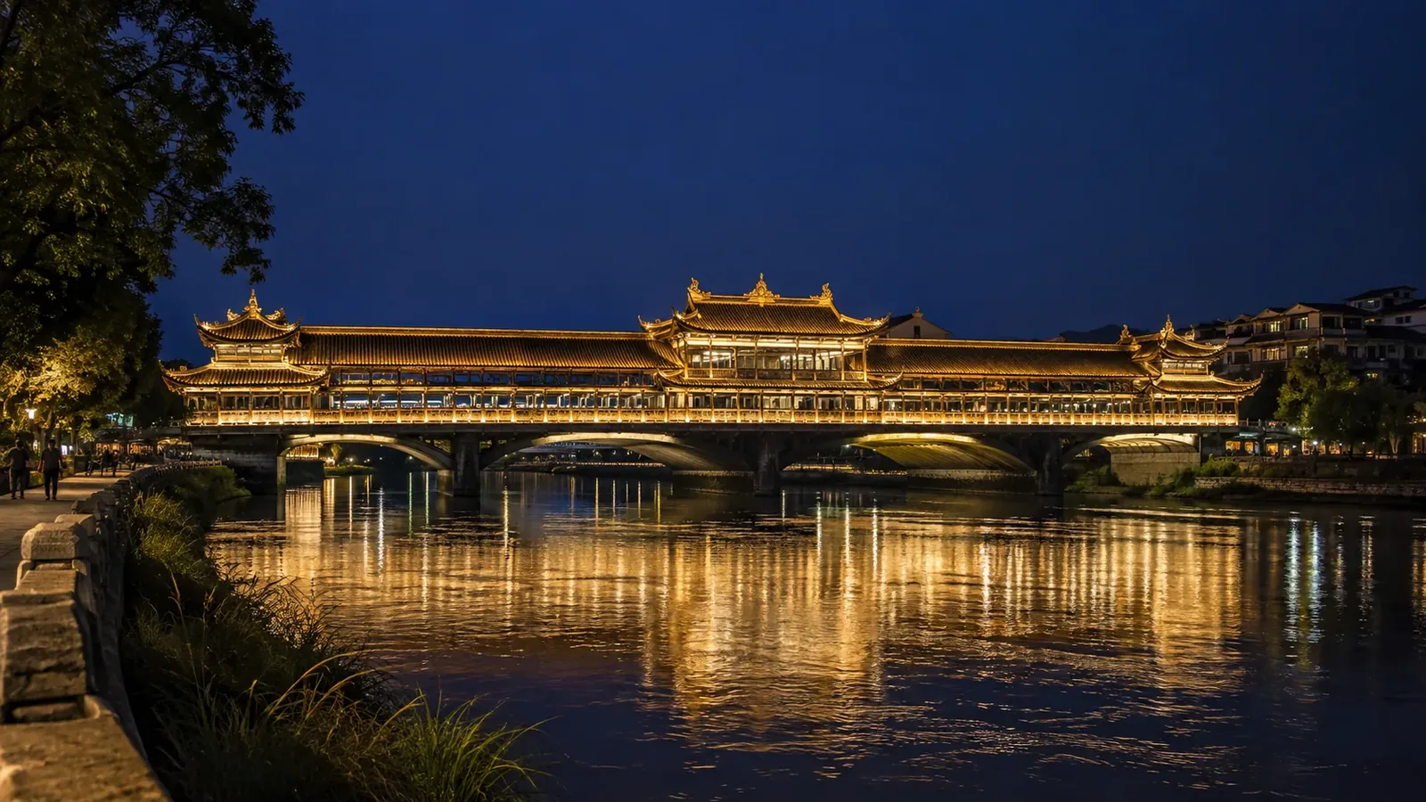 Nanqiao Bridge illuminated at night beside the river in Dujiangyan, Sichuan