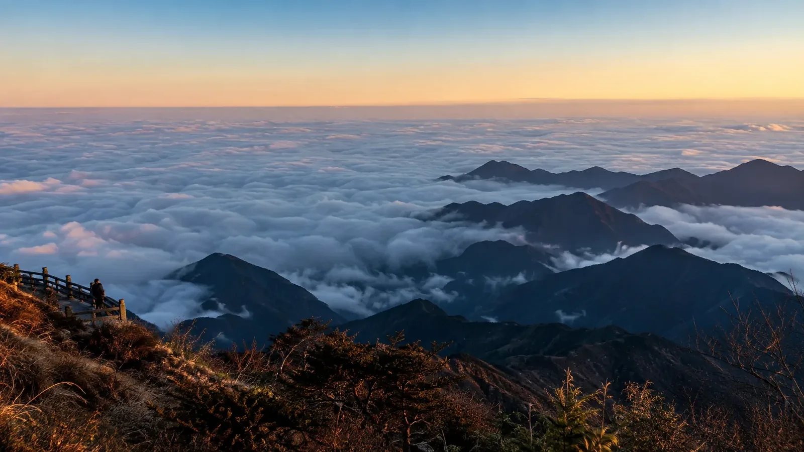 Sea of clouds below Mount Emei with layered mountain ridges in early morning light